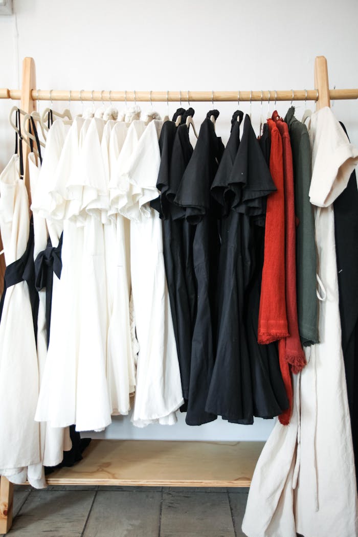 A stylish display of black, white, and red dresses hanging in a boutique, showcasing contemporary fashion.